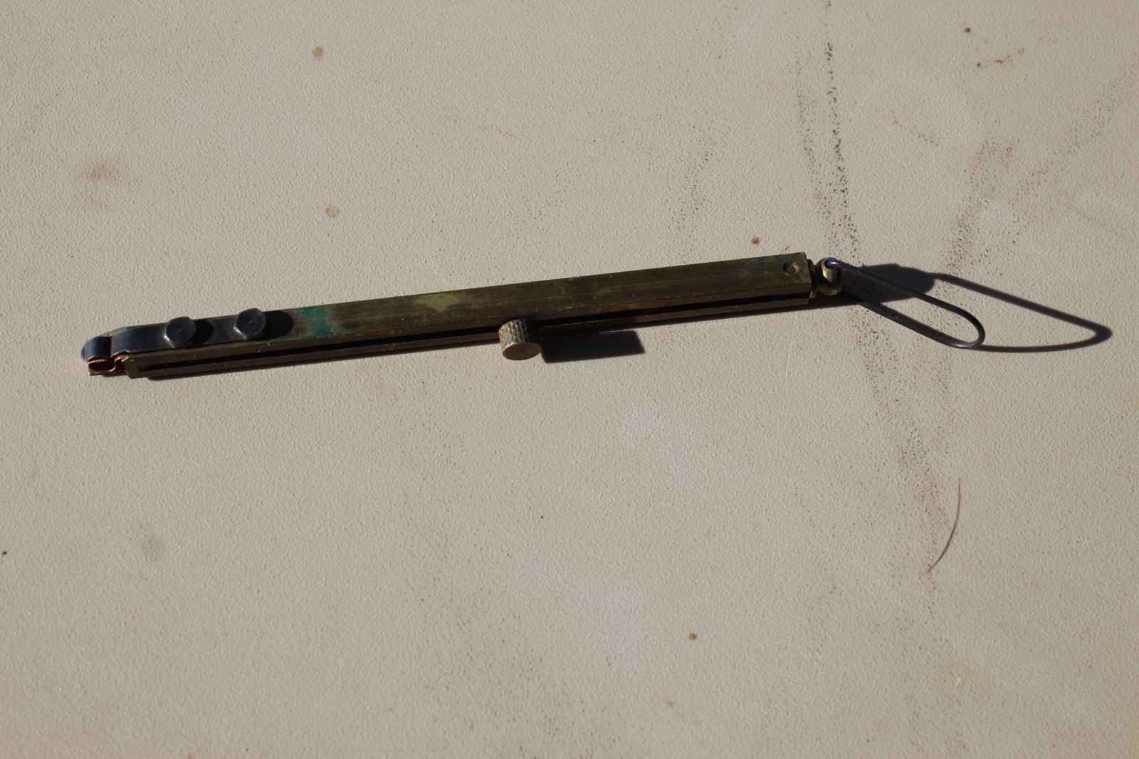 Brass straight-line percussion capper