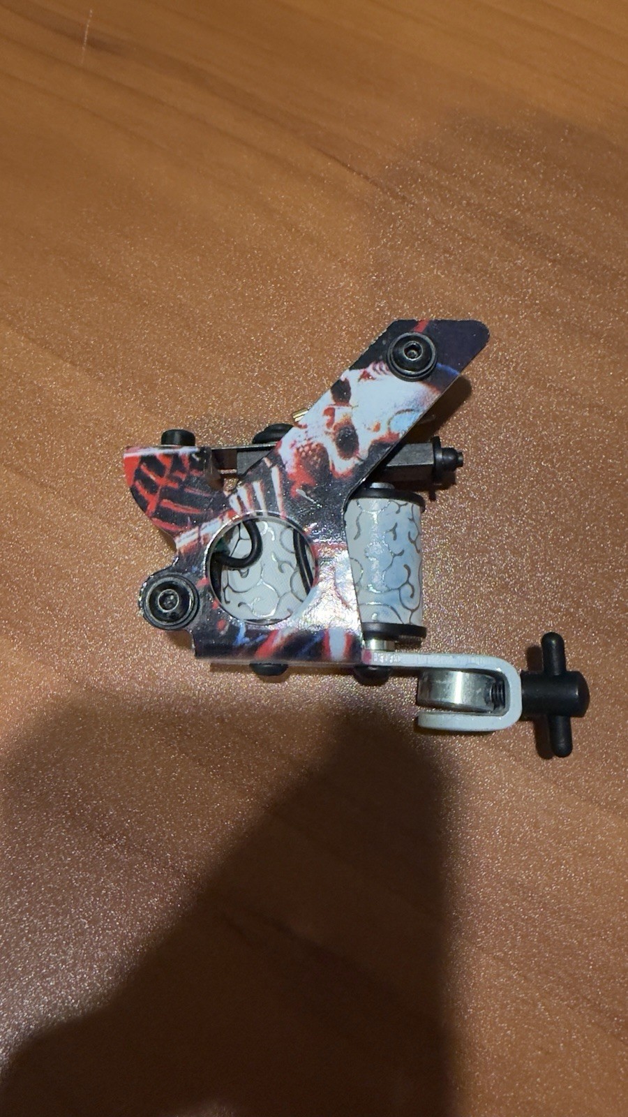 Dragonhawk coil tattoo machine featuring a distinctive skull design