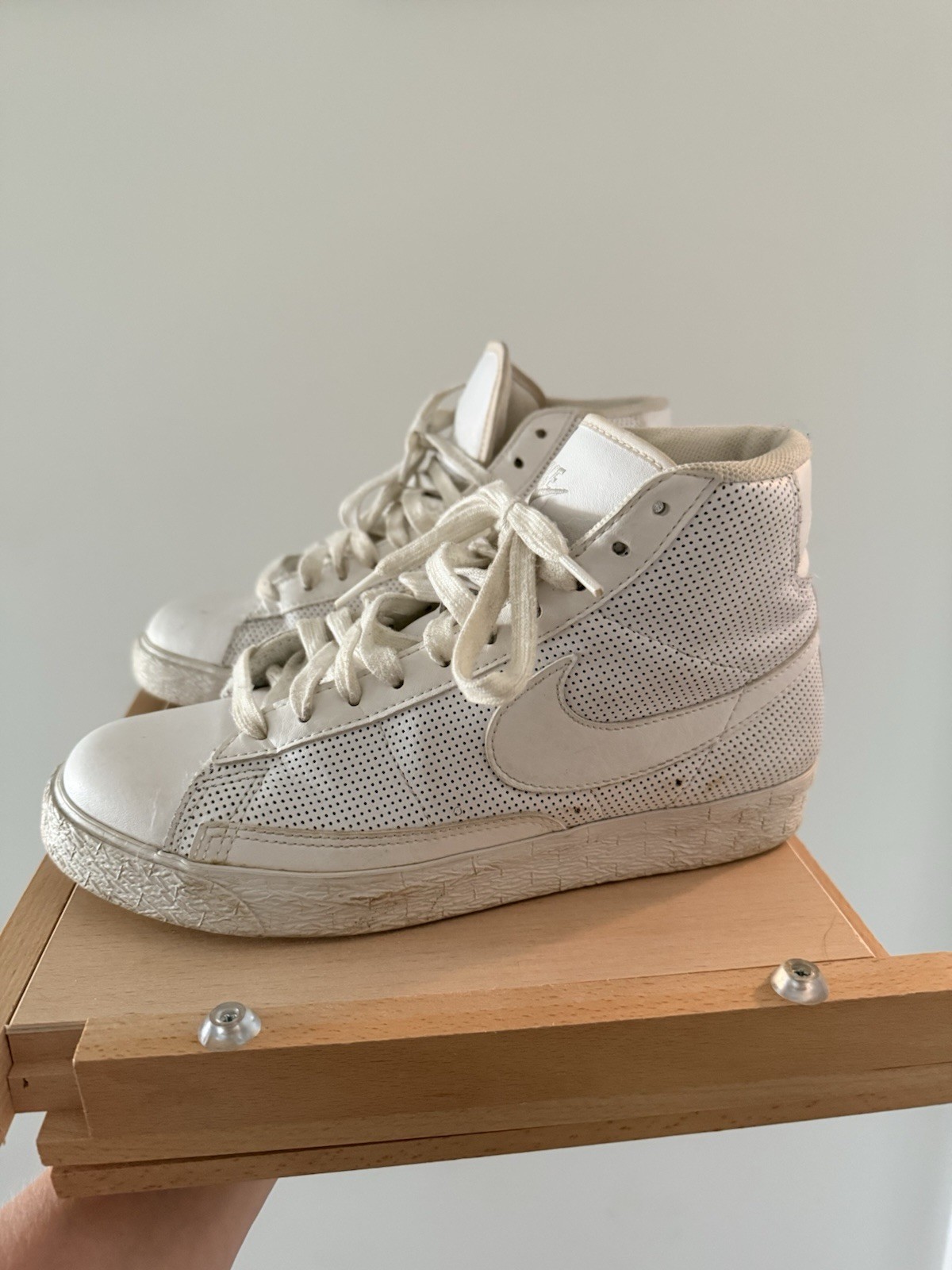 Nike Blazer Mid Sneakers in a white leather colorway, featuring high-top design