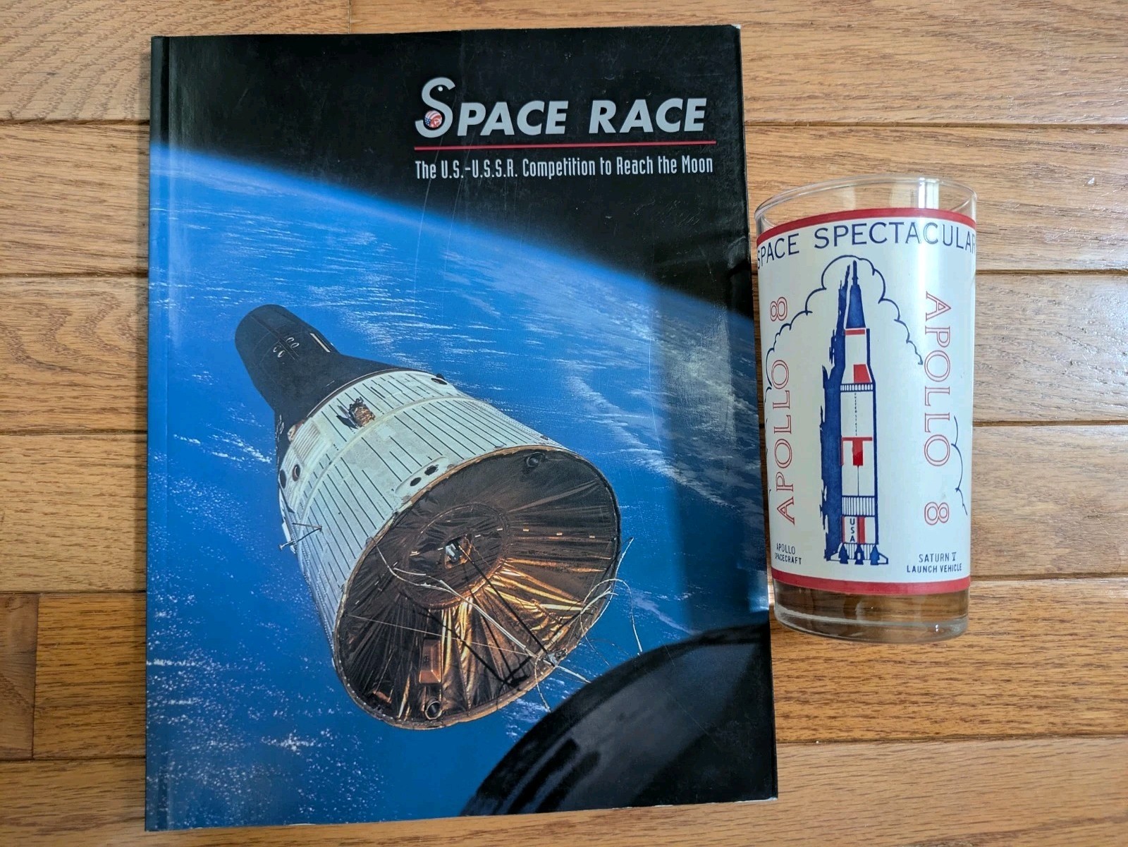 2 items: Apollo 8 moon Saturn V glass + book "Space Race: The U.S.-U.S.S.R. ..."