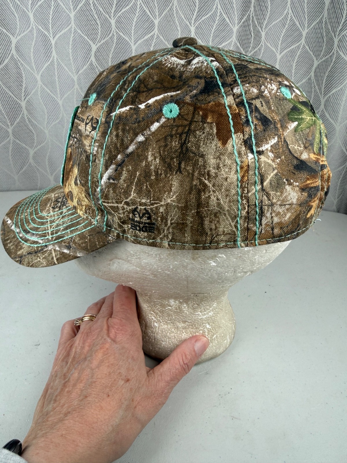 Real Tree Gold Sparkle Logo Black Aqua Rivet Patch on Camouflage Hat Cap