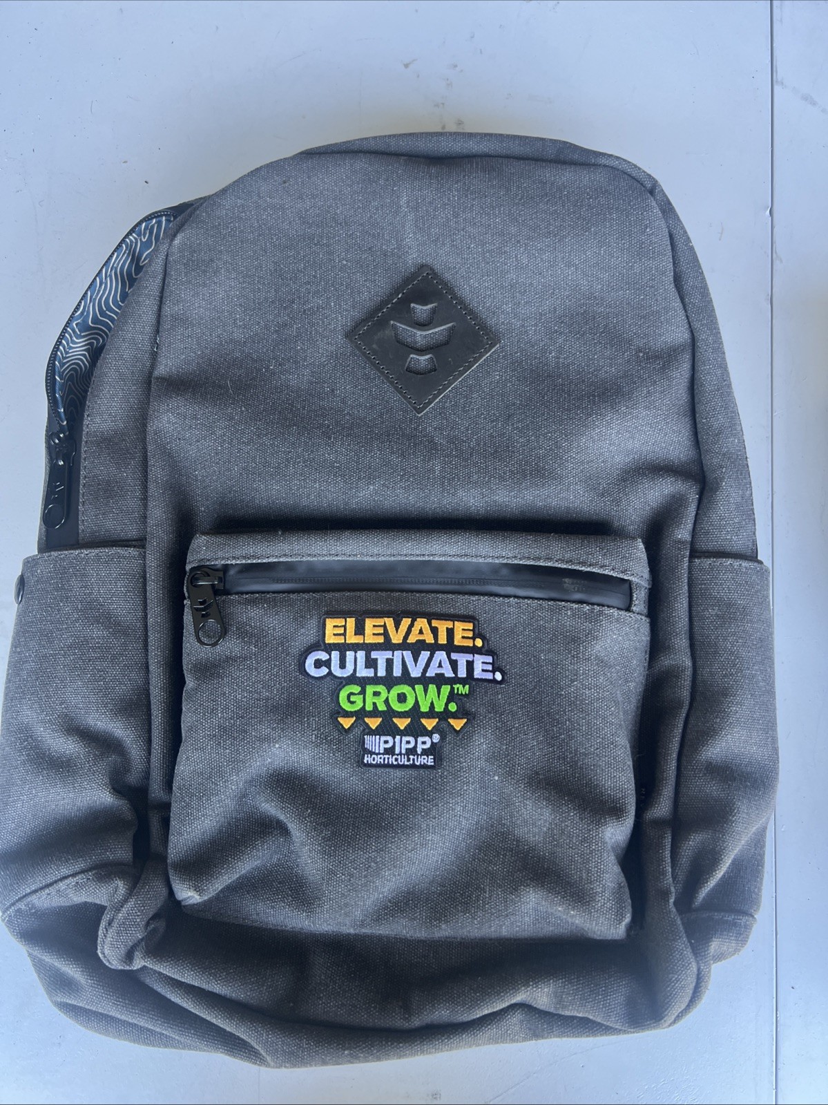 REVELRY ODOR PROOF WATER RESISTANT THE ESCORT BACKPACK Gray PIPP Logo