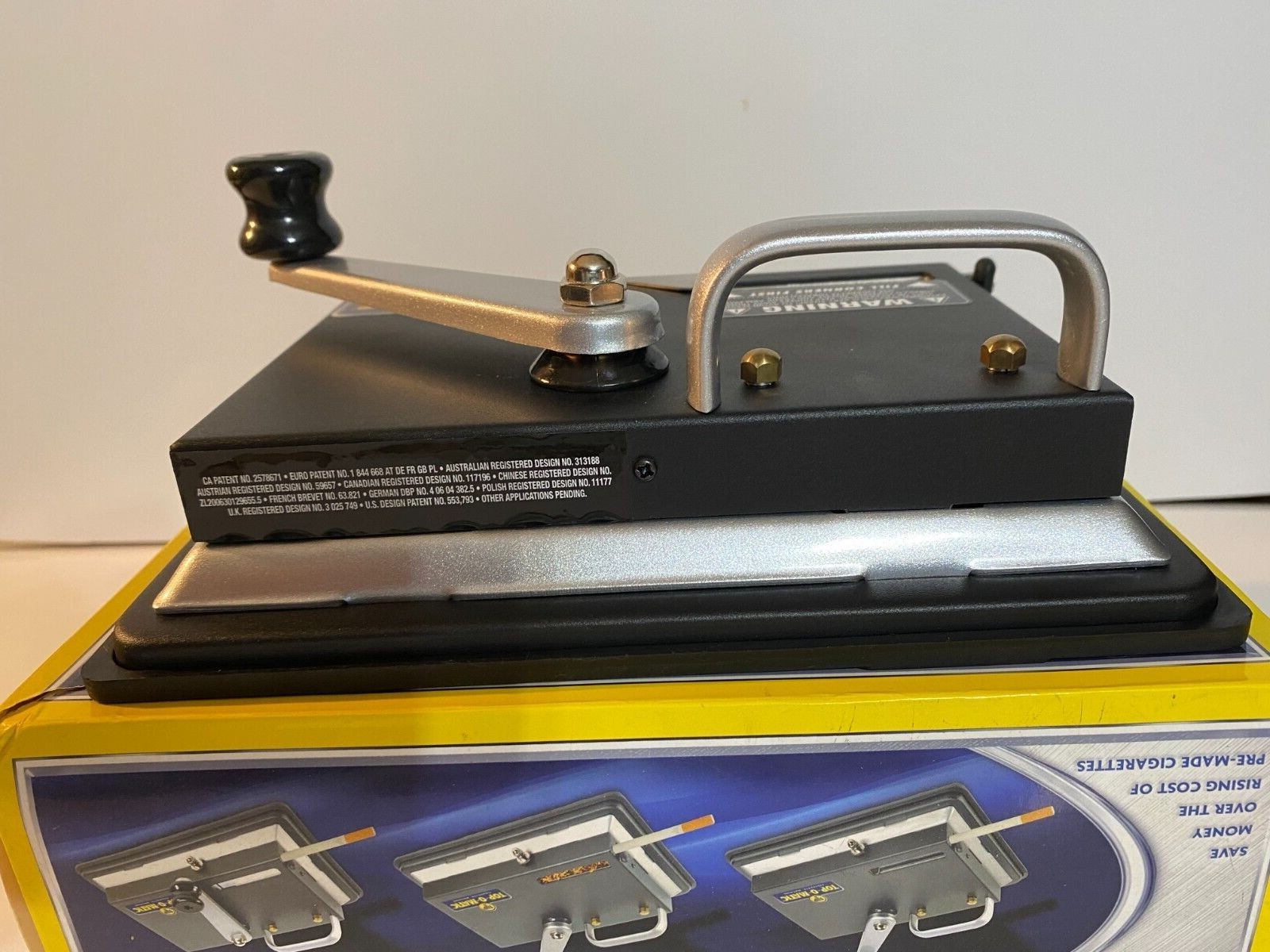 BRAND NEW, OPEN BOX, NEVER USED, TOP-O-MATIC CIGARETTE ROLLING MACHINE.