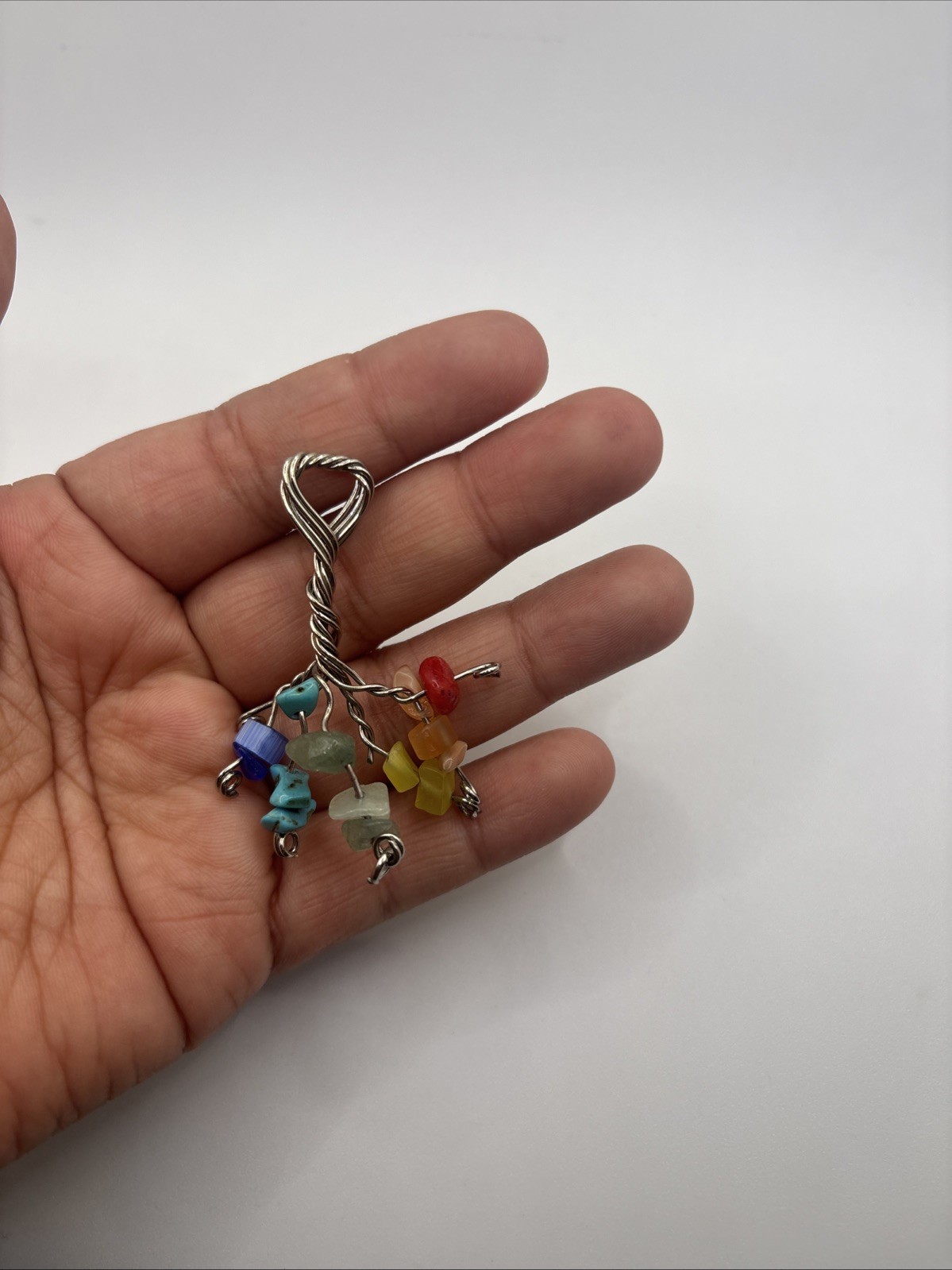 This is a handmade wire-wrapped keychain featuring multicolored gemstone chip