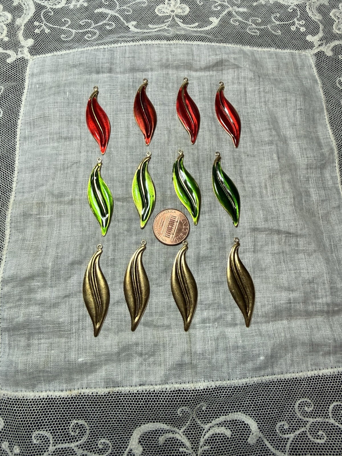 12 vintage narrow leaf brass dangles: 4 each of  3 colors: red, green, raw brass