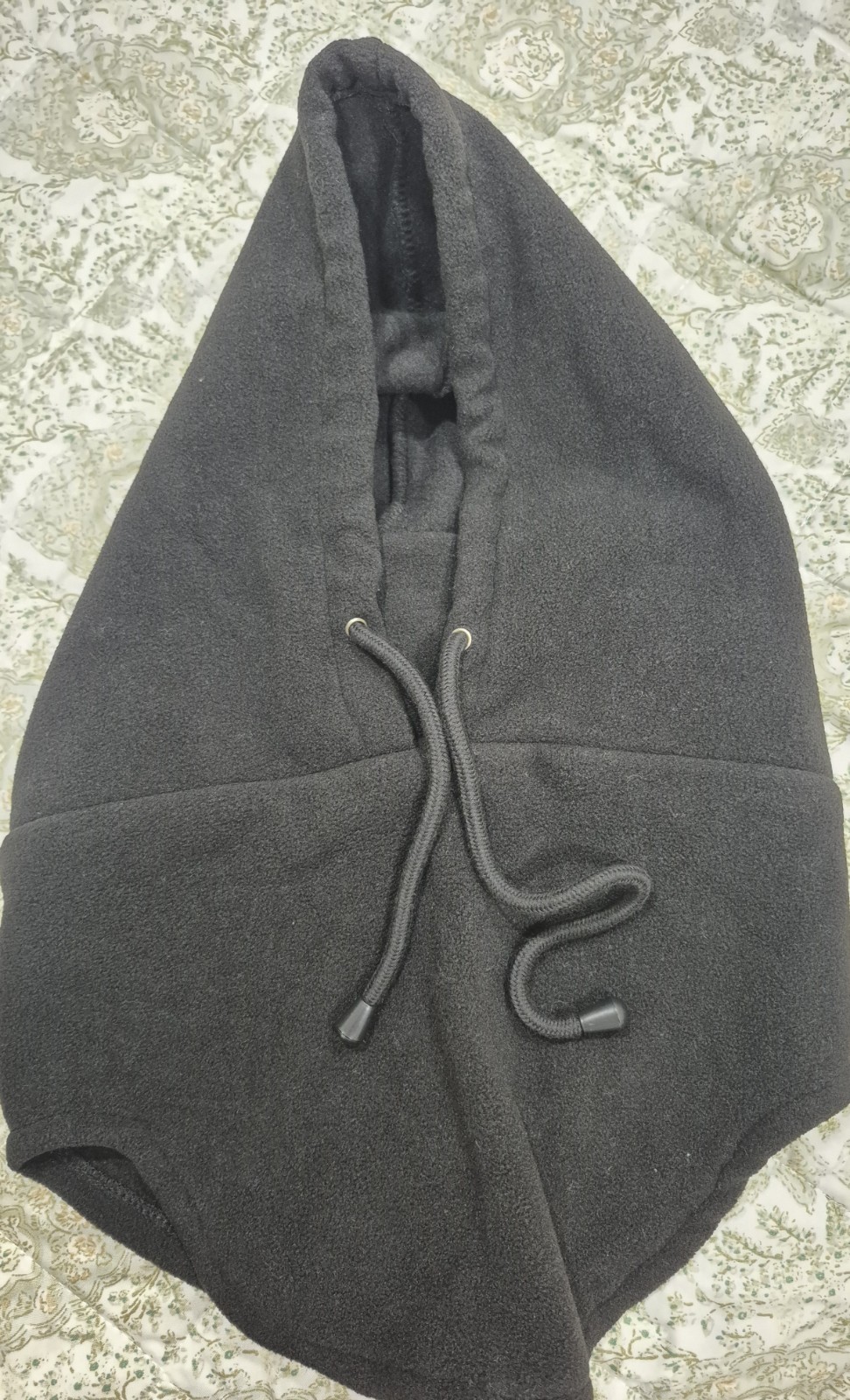 Standard unisex black balaclava, breathable with drawstring adjustment.