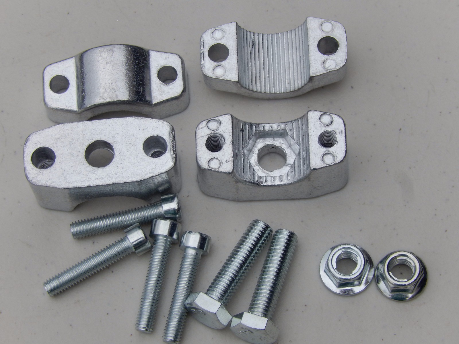 A PAIR OF HANDLE BAR CLAMP WITH MOUNTING HARDWARE FITS 7/8" MINI BIKE,CHOPPERS