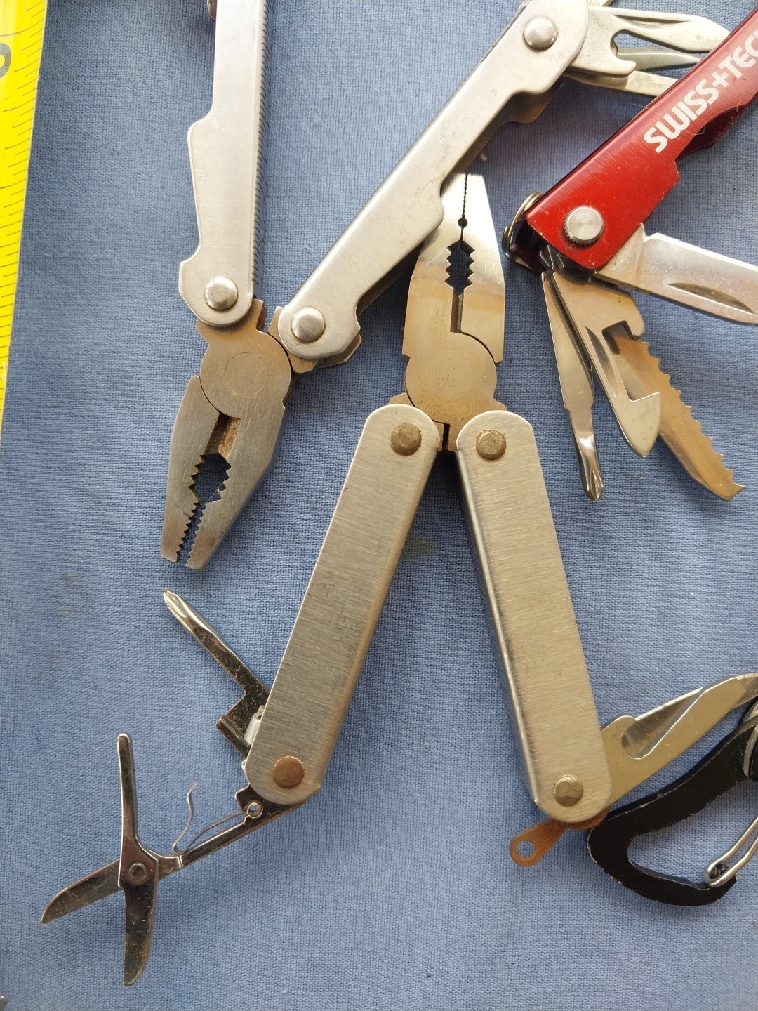 4 small multitudes with pliers knife scissors screwdriver's