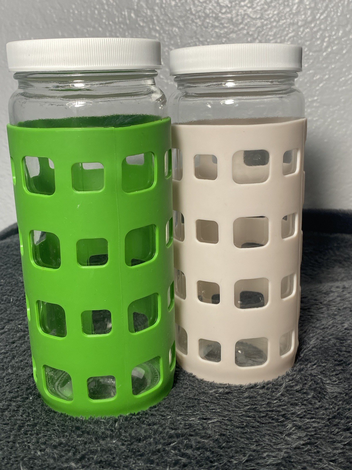 Two 16oz glass bottles with plastic lids and removable rubber sleeve