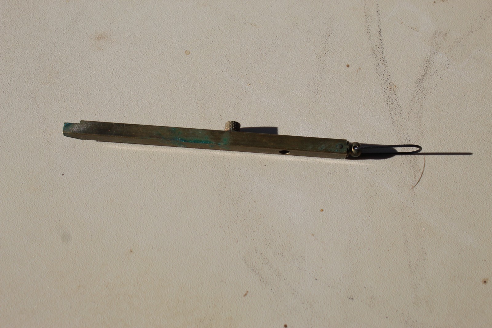 Brass straight-line percussion capper