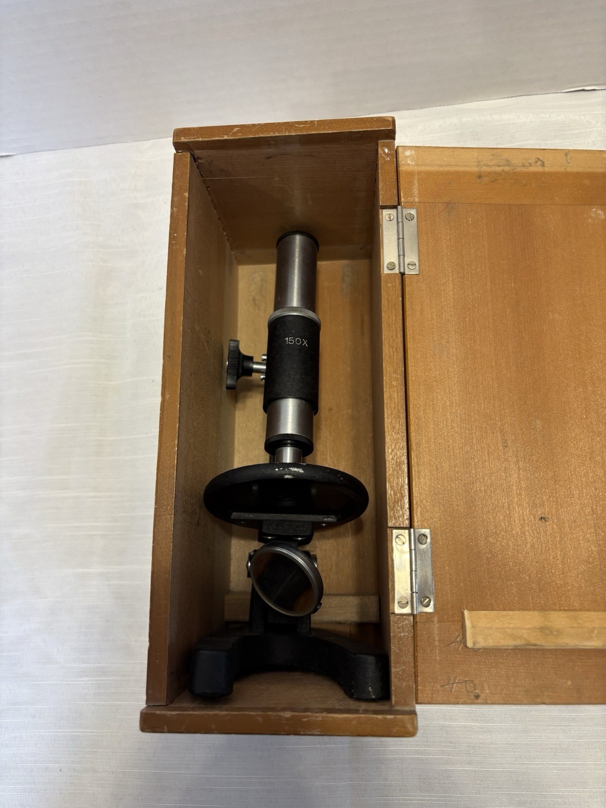 Vintage monocular student microscope, marked "GXO" and "JAPAN," educational use.