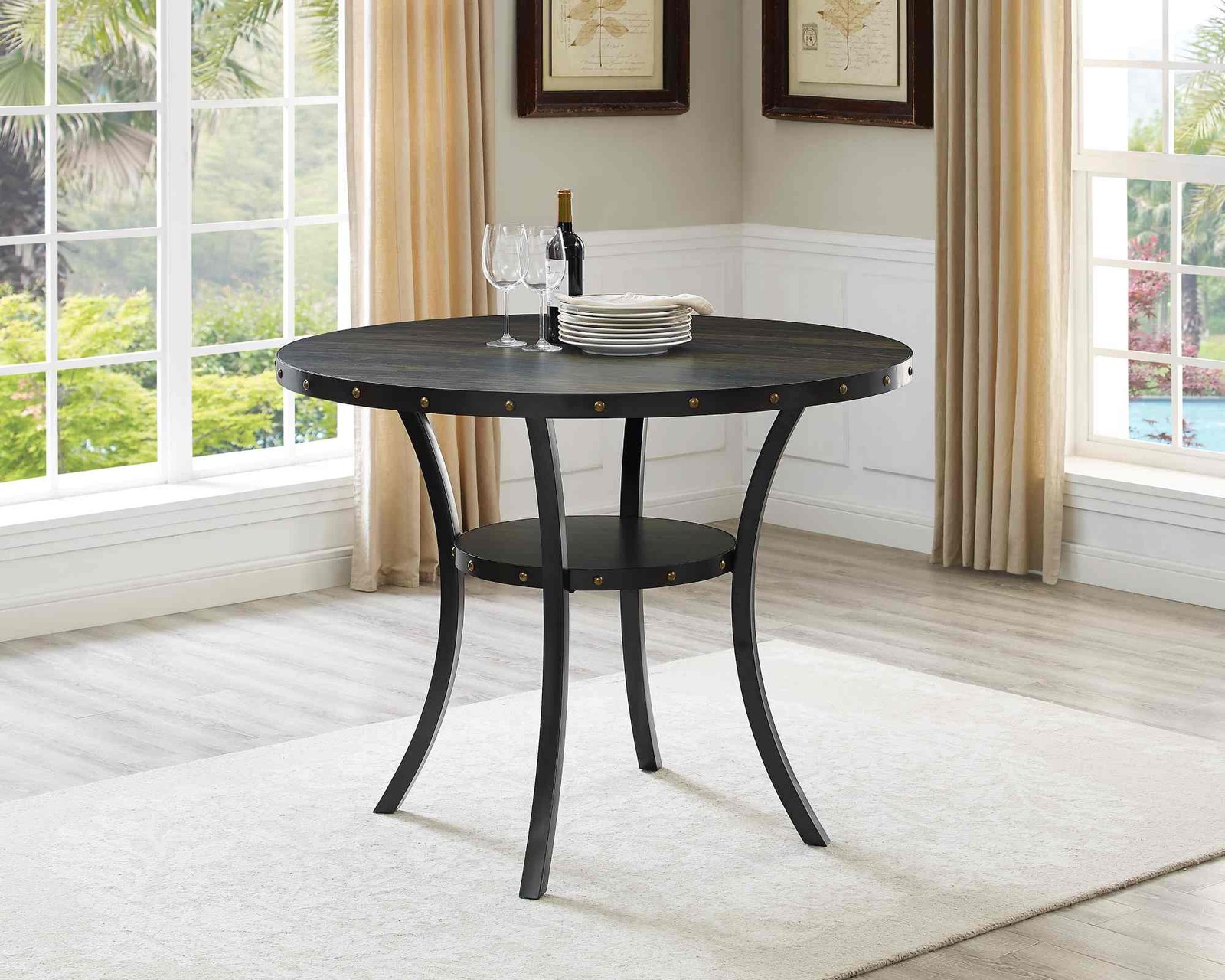 A round dining table with a counter height and a nail head