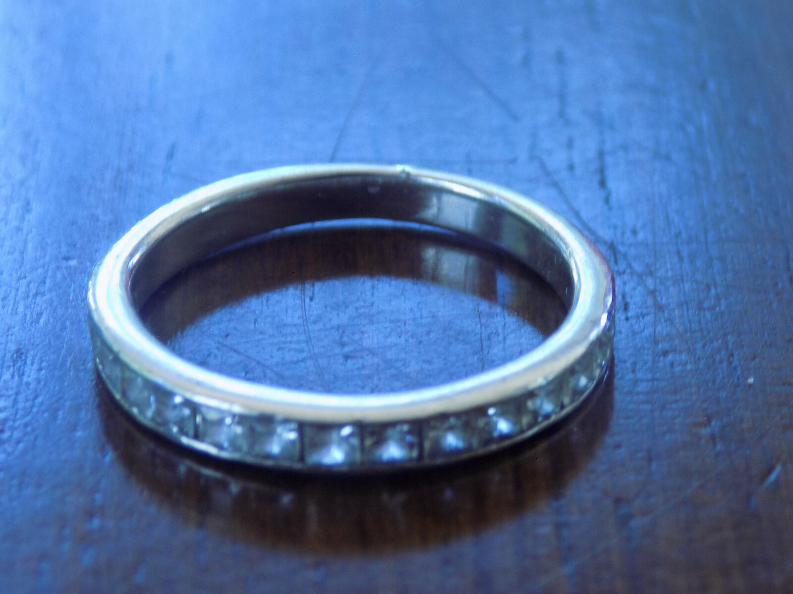 Size 7,  silver tone  eternity band with clear cz around front center (194)