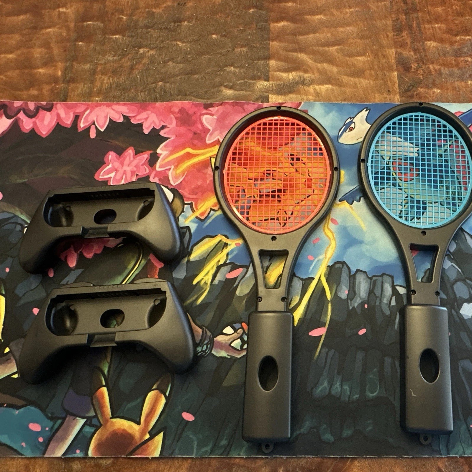 Set of 2 Nintendo Switch Joycon Controllers and 2 Joycon Tennis Racquets.