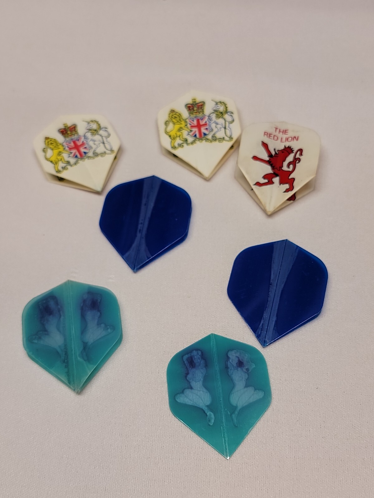 Red Lion(3)and blue flights (2) and Auqua Naked Lady (2) Dart Flights total 7