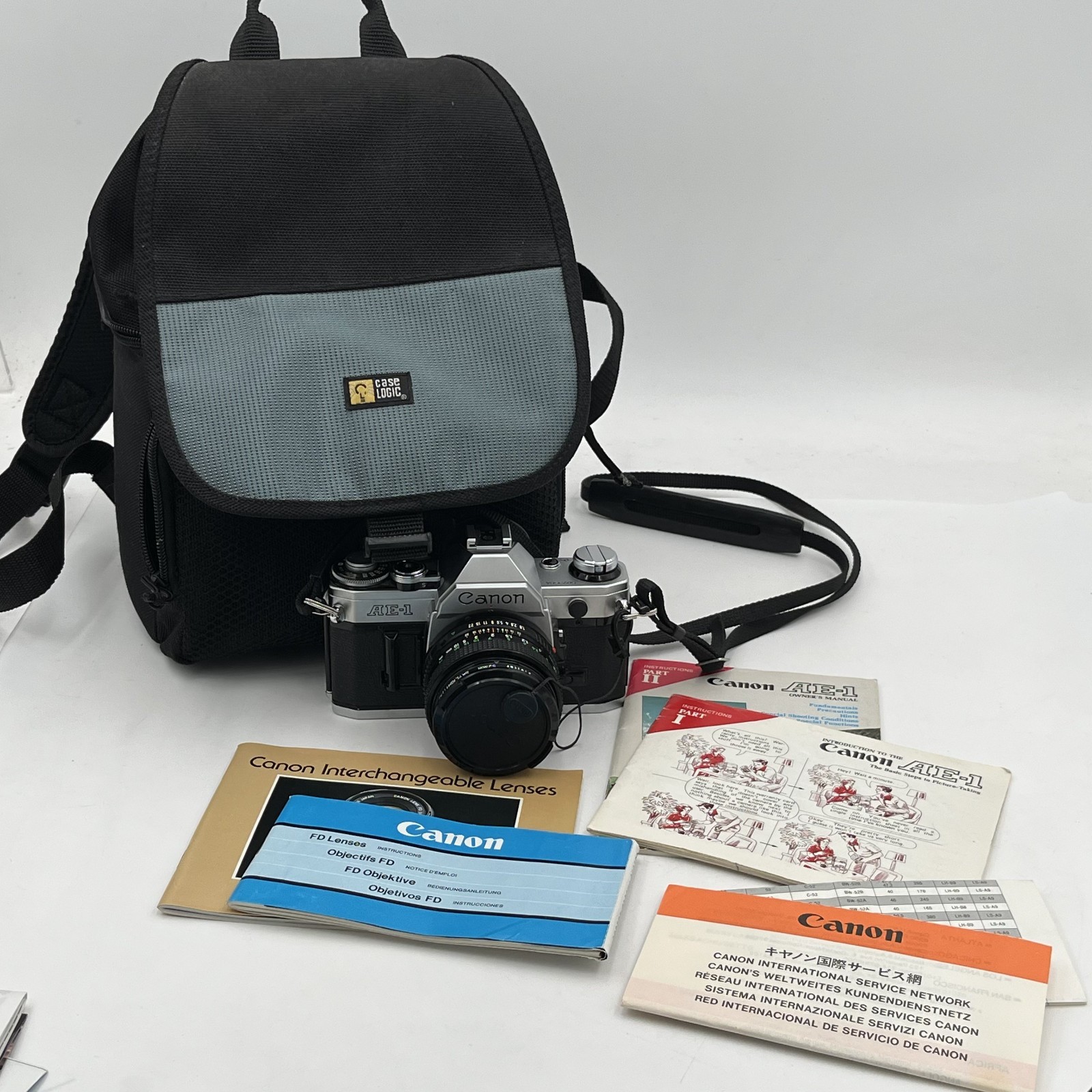 Vtg Canon AE-1 35mm Camera Bundle W Lens Manuals Film Case Backpack Extras