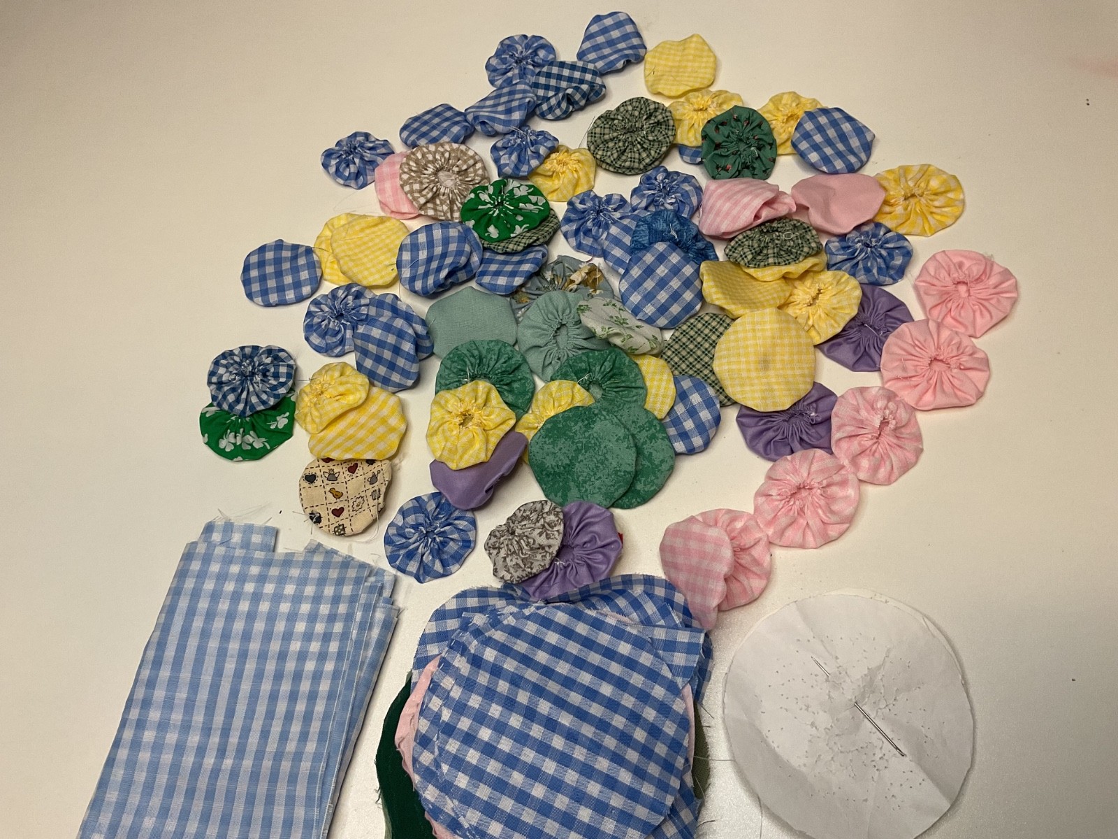1" fabric yo-yos for quilt different stages of completion checks solids florals