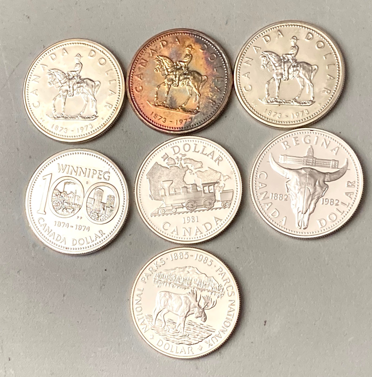 CANADA SILVER DOLLARS (7) 3-1973,1-1974, 1-1981, 1-1982, 1-1985 EACH 500 SILVER