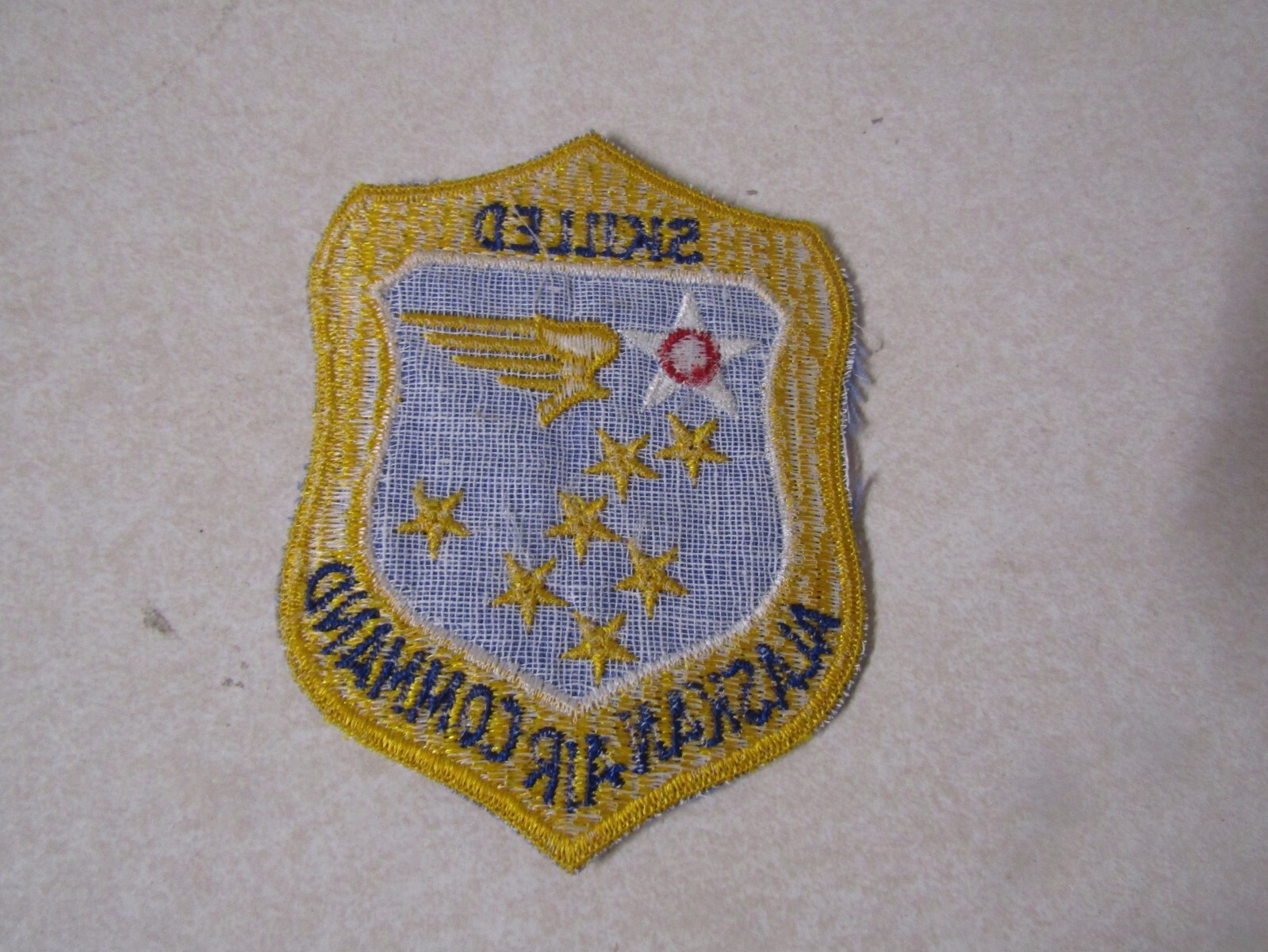 MILITARY PATCH OLDER US AIR FORCE SQUADRON ALASKAN AIR COMMAND "SKILLED" YELLOW
