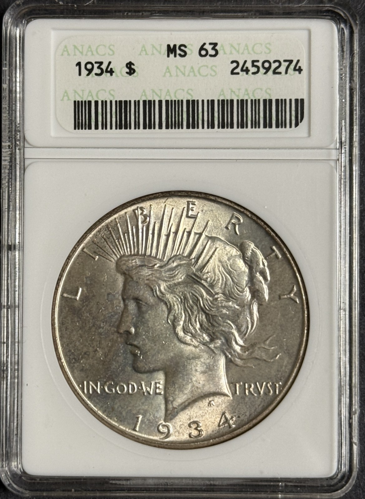 1934 Peace Silver Dollar, MS63 ANACS Soapbox Holder. (12442)