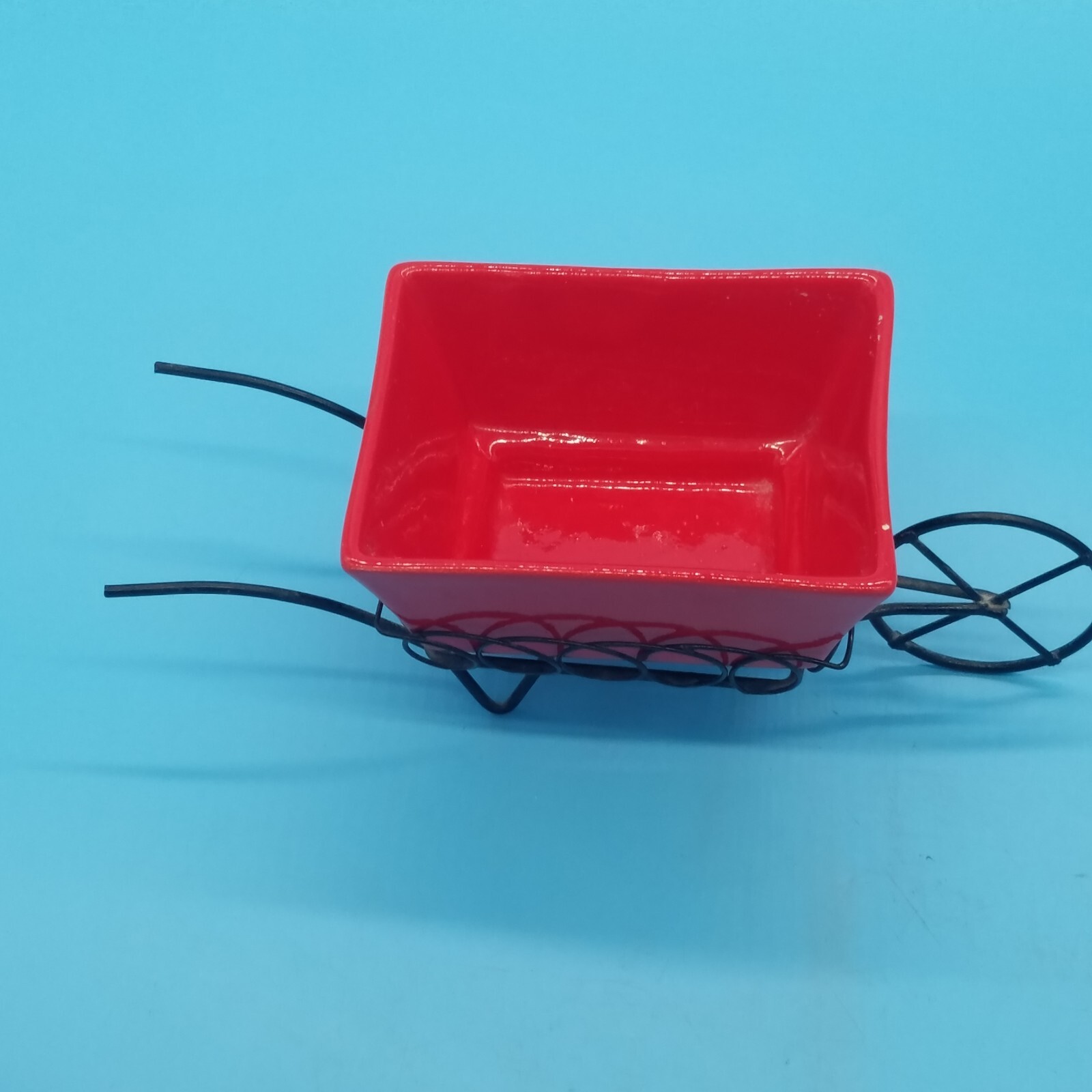 Red ceramic wheelbarrow with metal frame planter all flower arrangements