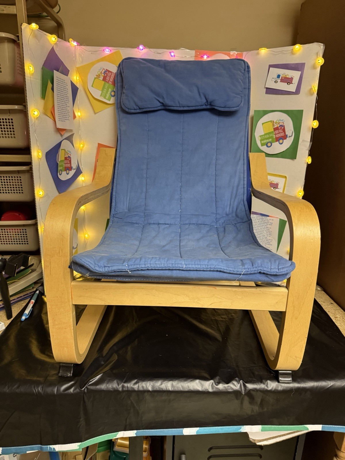 IKEA POÄNG children's armchair featuring a birch veneer frame and a blue cushion