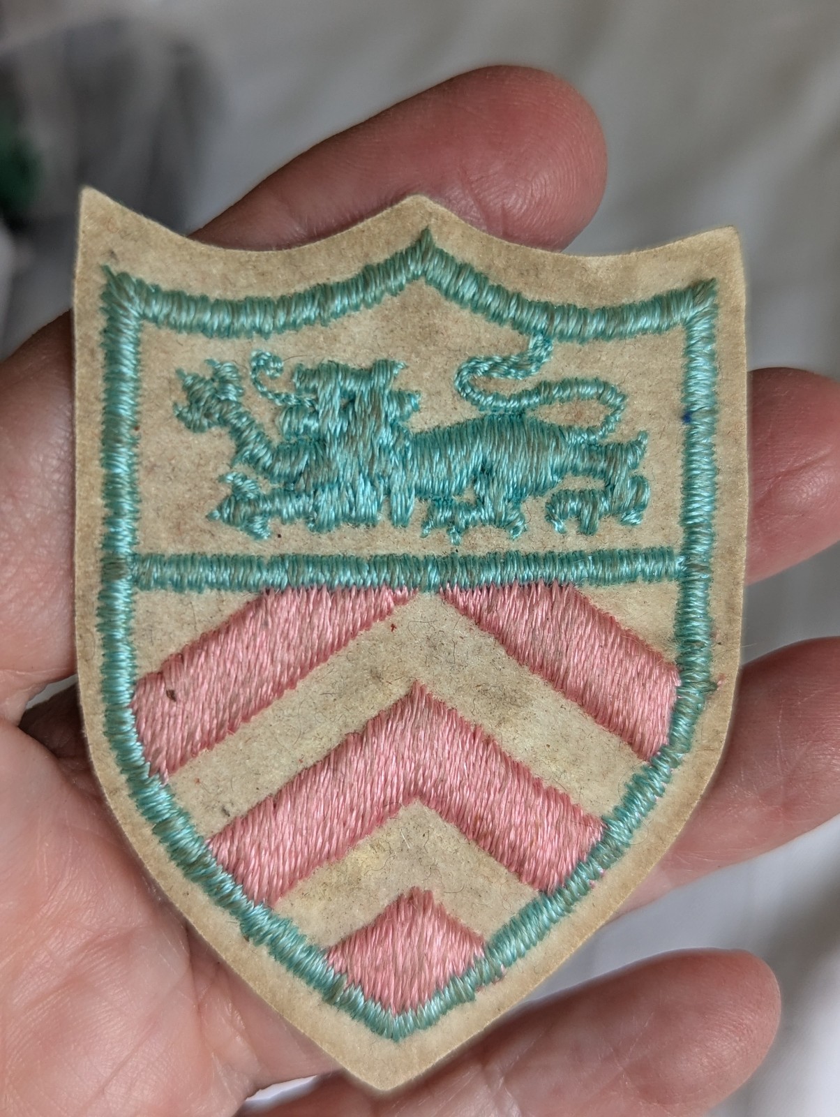 Shield shaped pink aqua blue lion embroidered patch 2.75" long
