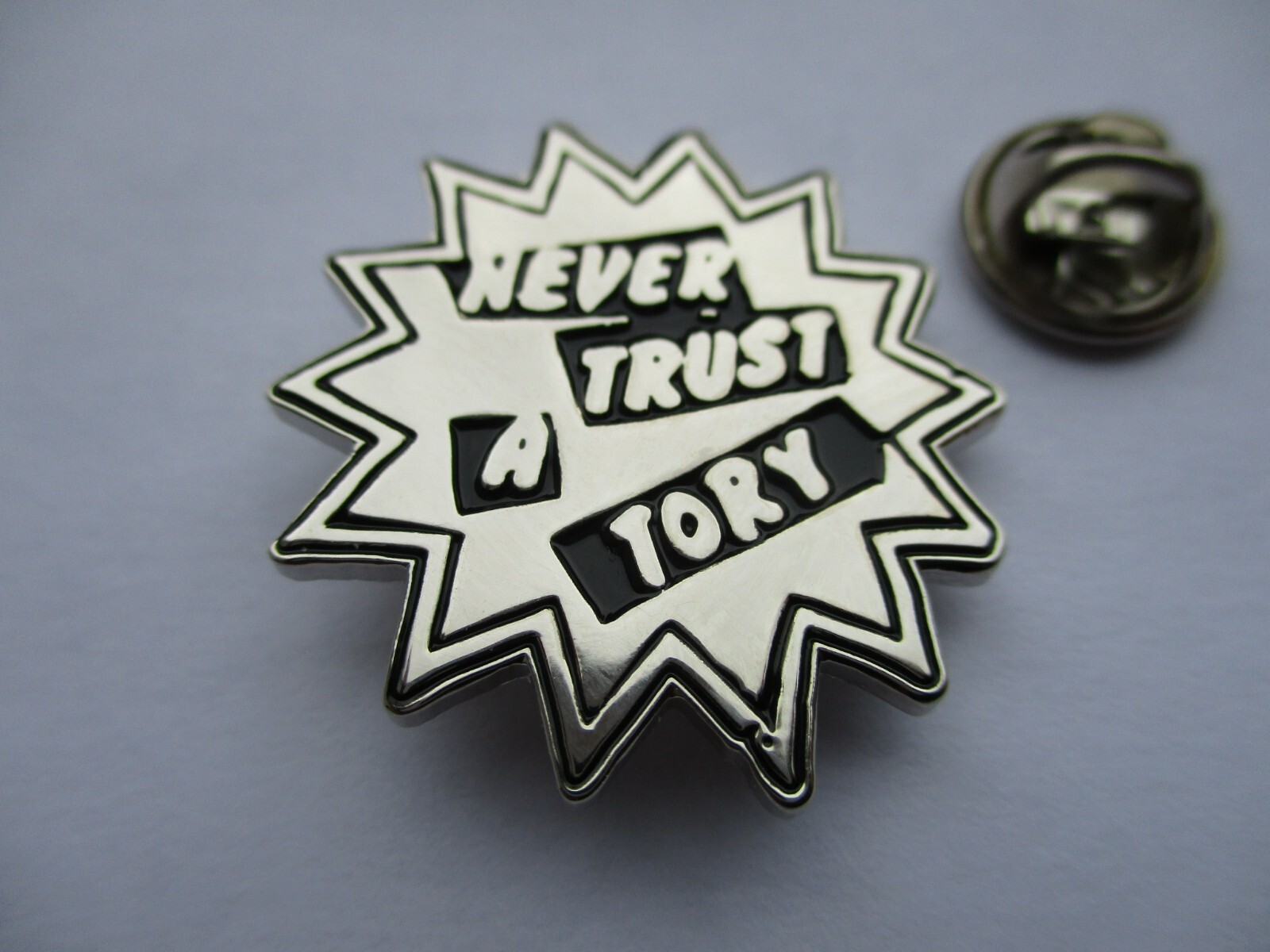 NEVER TRUST A TORY METAL BADGE anti tory enamel pin , silver