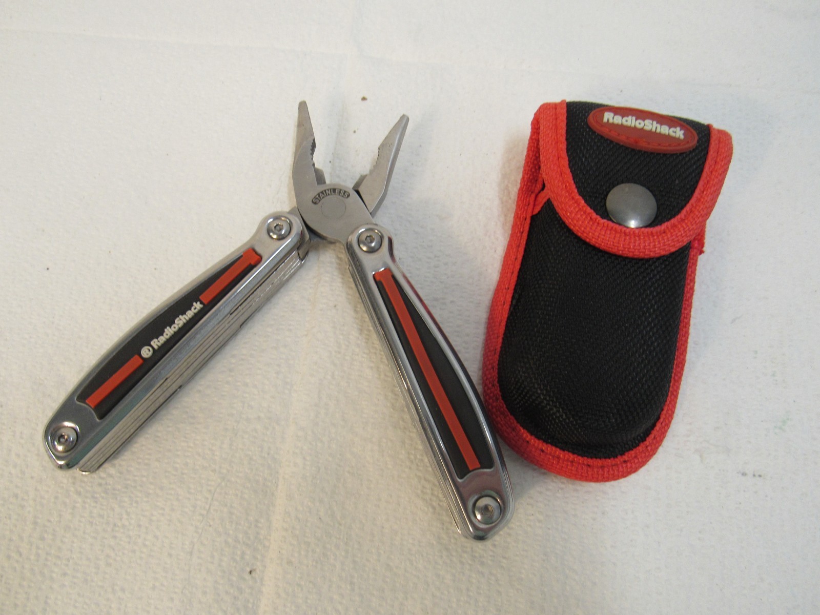 Radio Shack Multi-Tool Stainless Steel With Belt Case Red, Black, Stainless