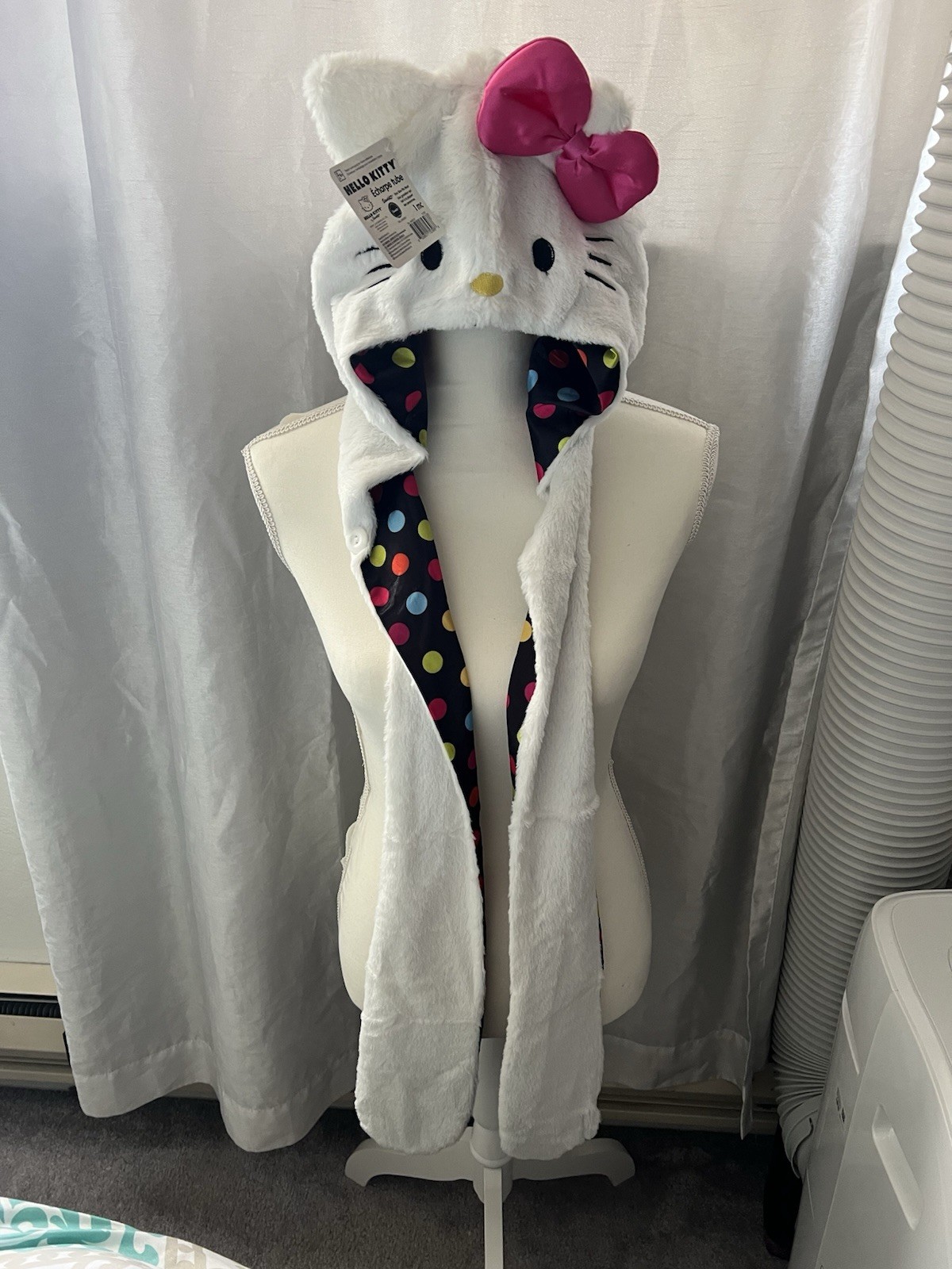 Hello Kitty Hat Hood in white with a pink bow and a polka dot lining.