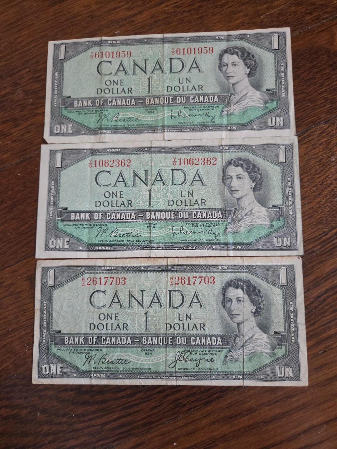 Three 1954 Canadian One Dollar Bills