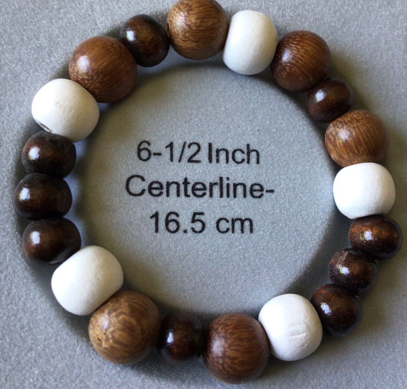 6.5" bracelet made with wood beads in different shades of brown. made in the USA