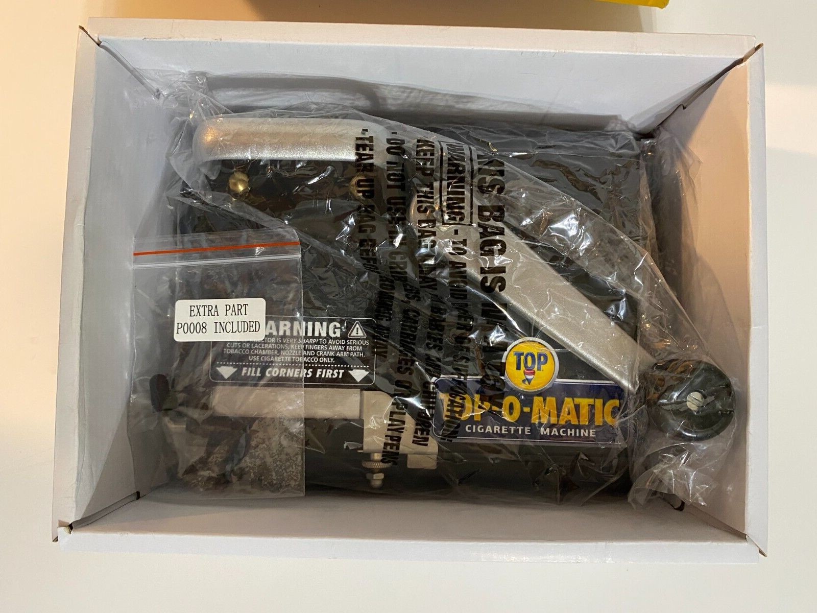 BRAND NEW, OPEN BOX, NEVER USED, TOP-O-MATIC CIGARETTE ROLLING MACHINE.
