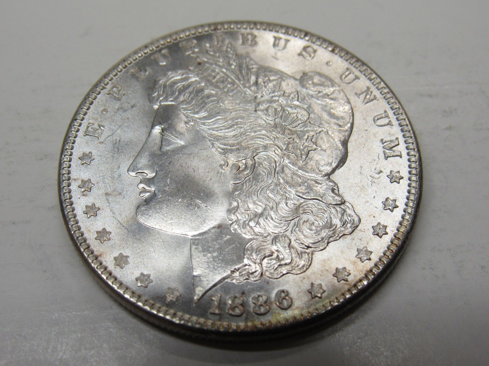 UNITED STATES 1886 MORGAN SILVER DOLLAR  AU CONDITION MIRROR FINISH *