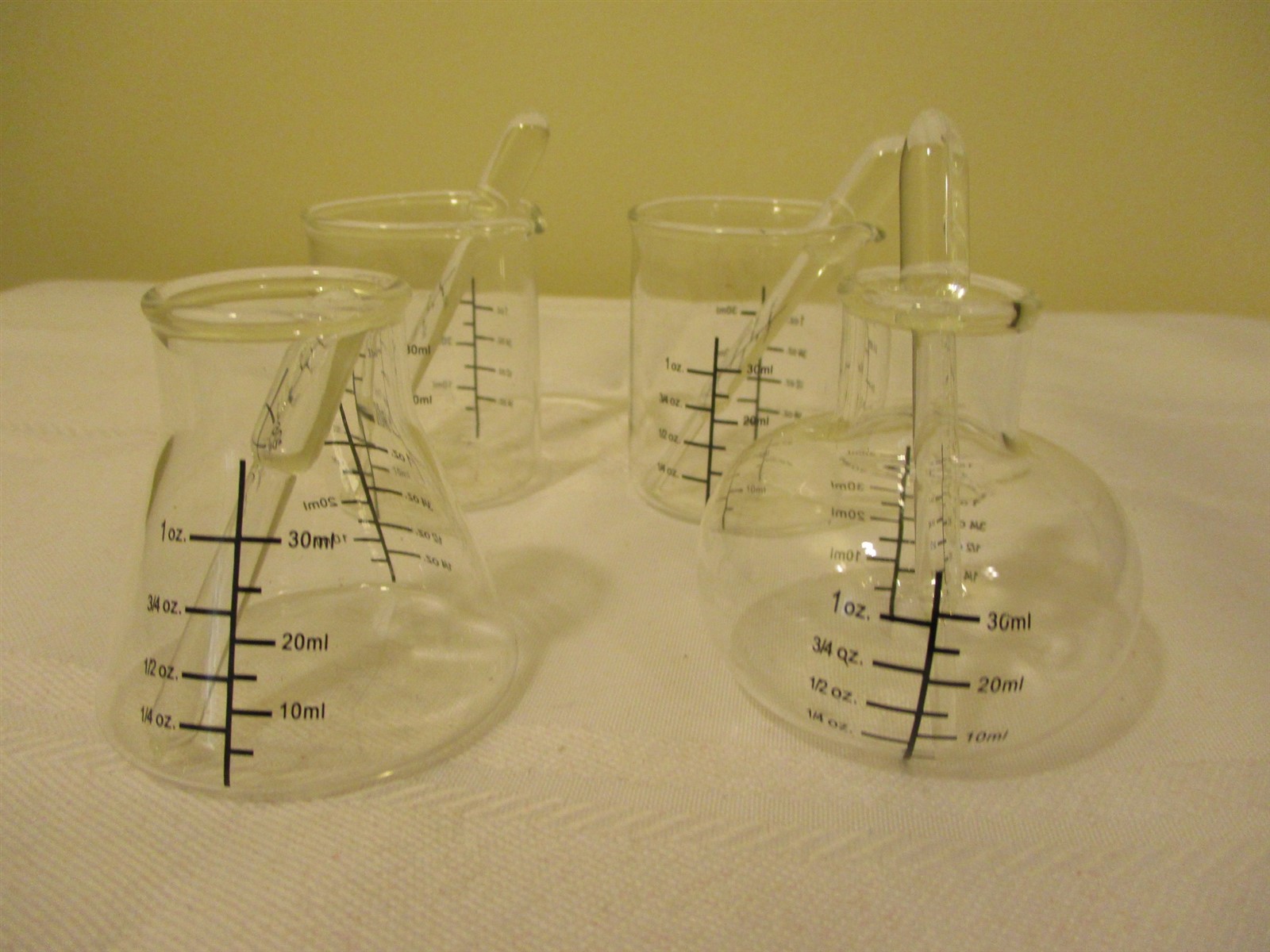 FOUR MINI / SMALL GLASS LABORATORY ? BEAKERS WITH STIRRERS / DIPPERS  1 OZ -30ML