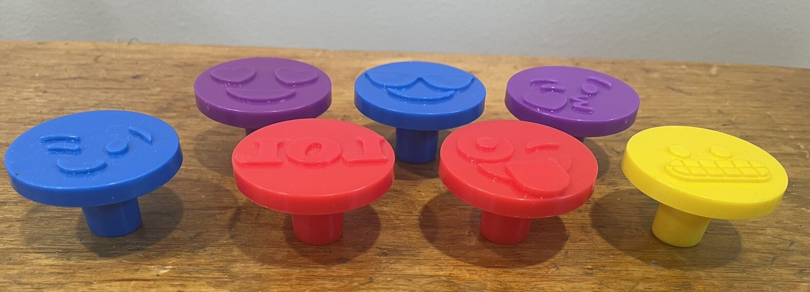 Seven emoji play doh presses