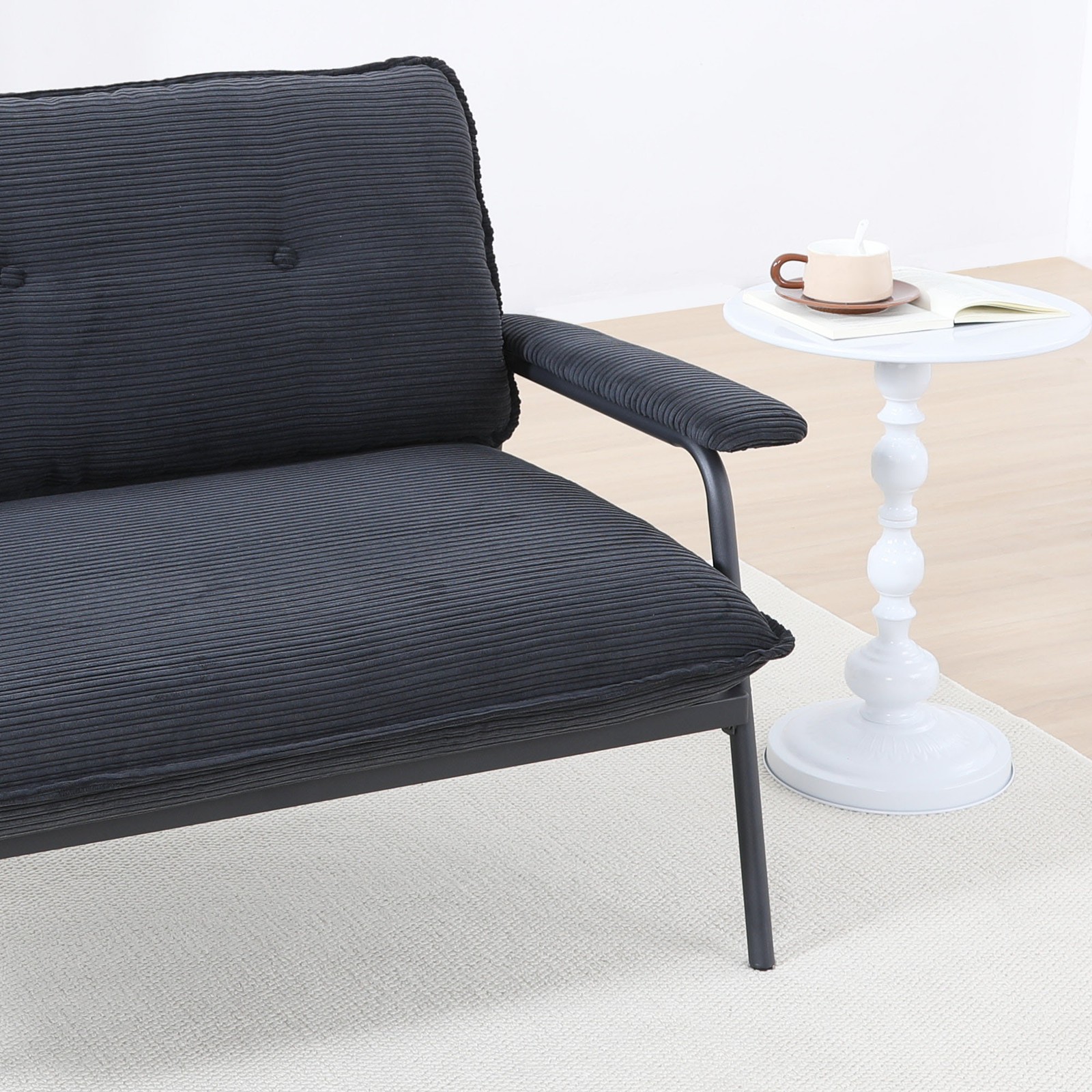 The 53-inch black sofa offers a spacious layout in the small apartment, easily