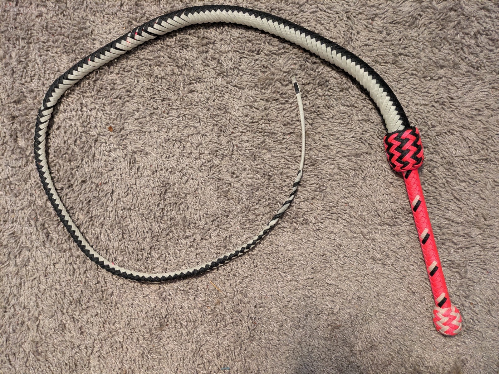 4ft paracord bull whip. 3 plaited layer. 12 inch handle. ends in tapered twist.