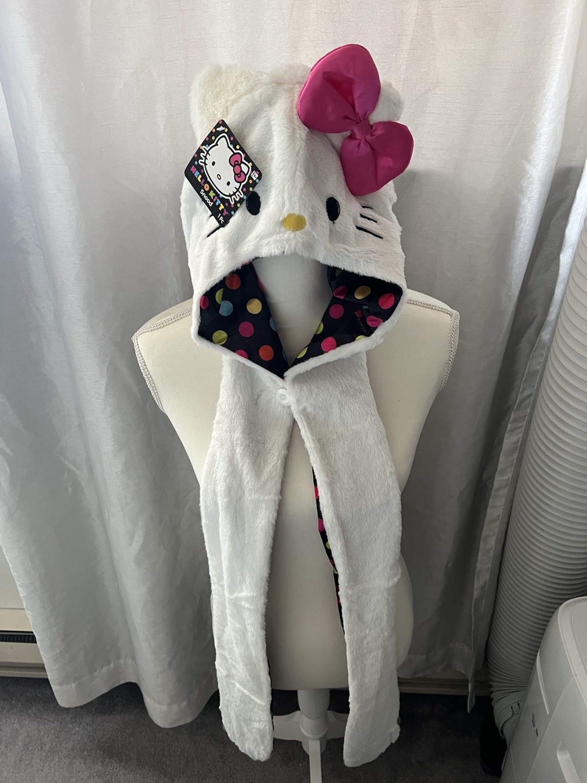 Hello Kitty Hat Hood in white with a pink bow and a polka dot lining.