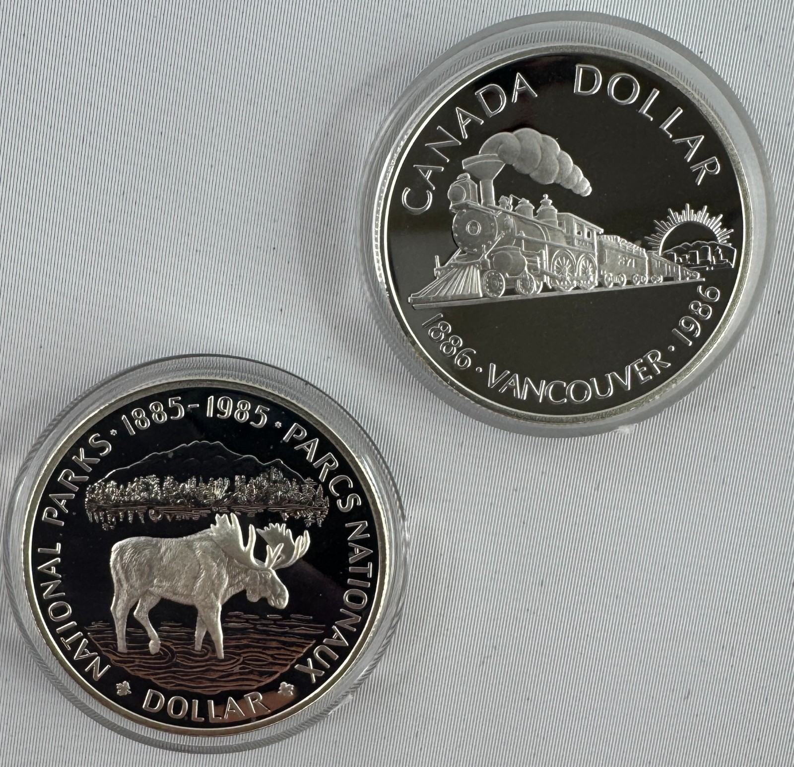 1985 + 1986 Canada Silver Dollar Proof 2-Coin Lot in Capsules RCM Moose Train