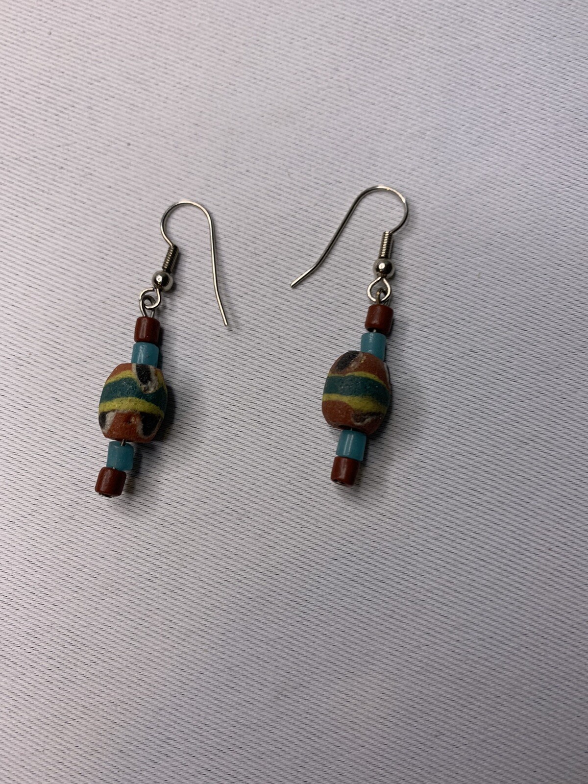 Silvertone and painted wood pierced earrings