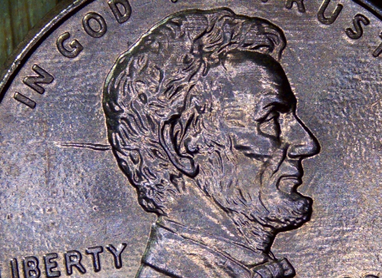 2002 d- rd Lincoln penny looks like there's a bullet going in the back of head