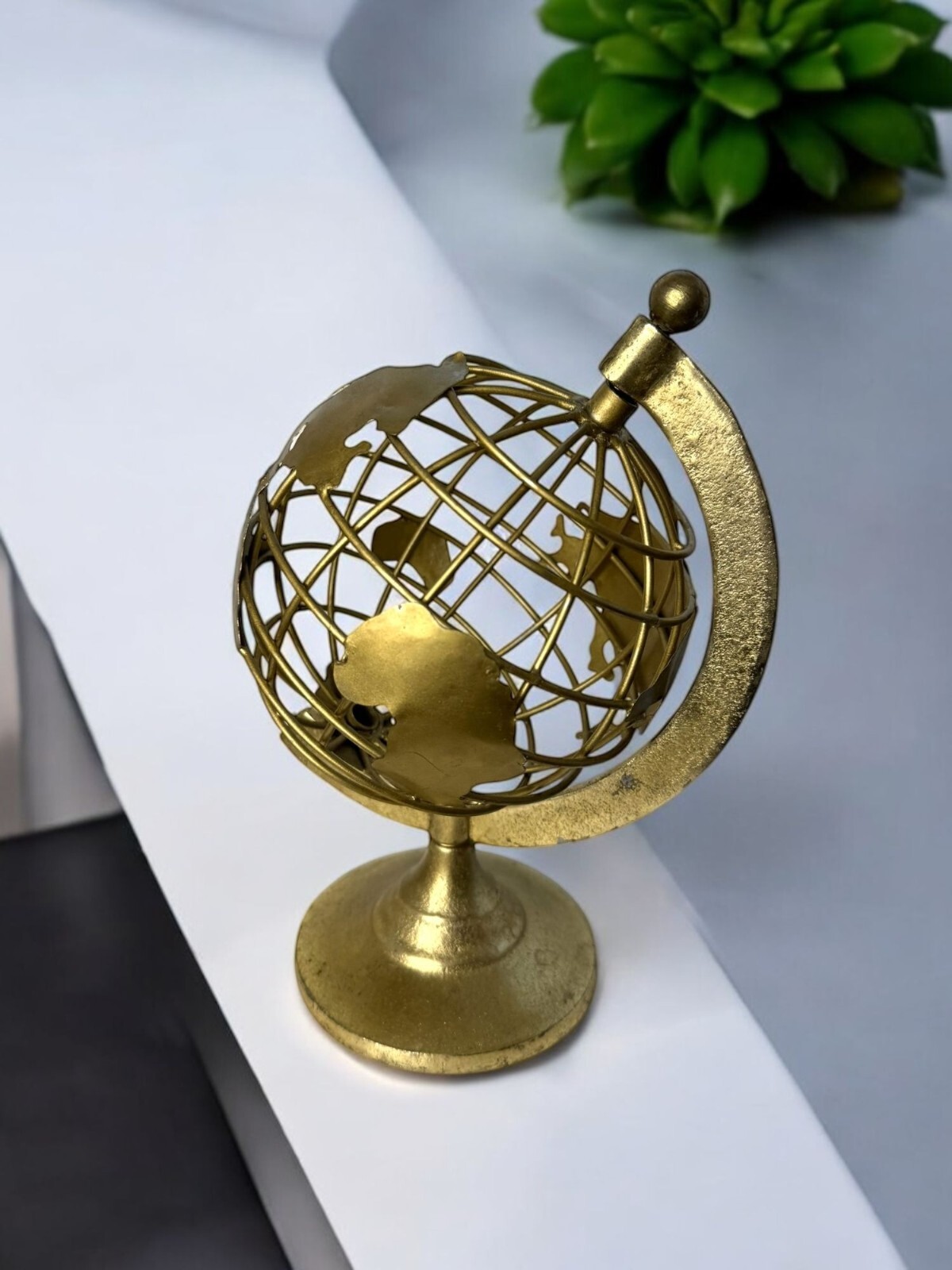 Gold Metal Decorative Globe Sculpture With Rotating Axis And Map Cutouts