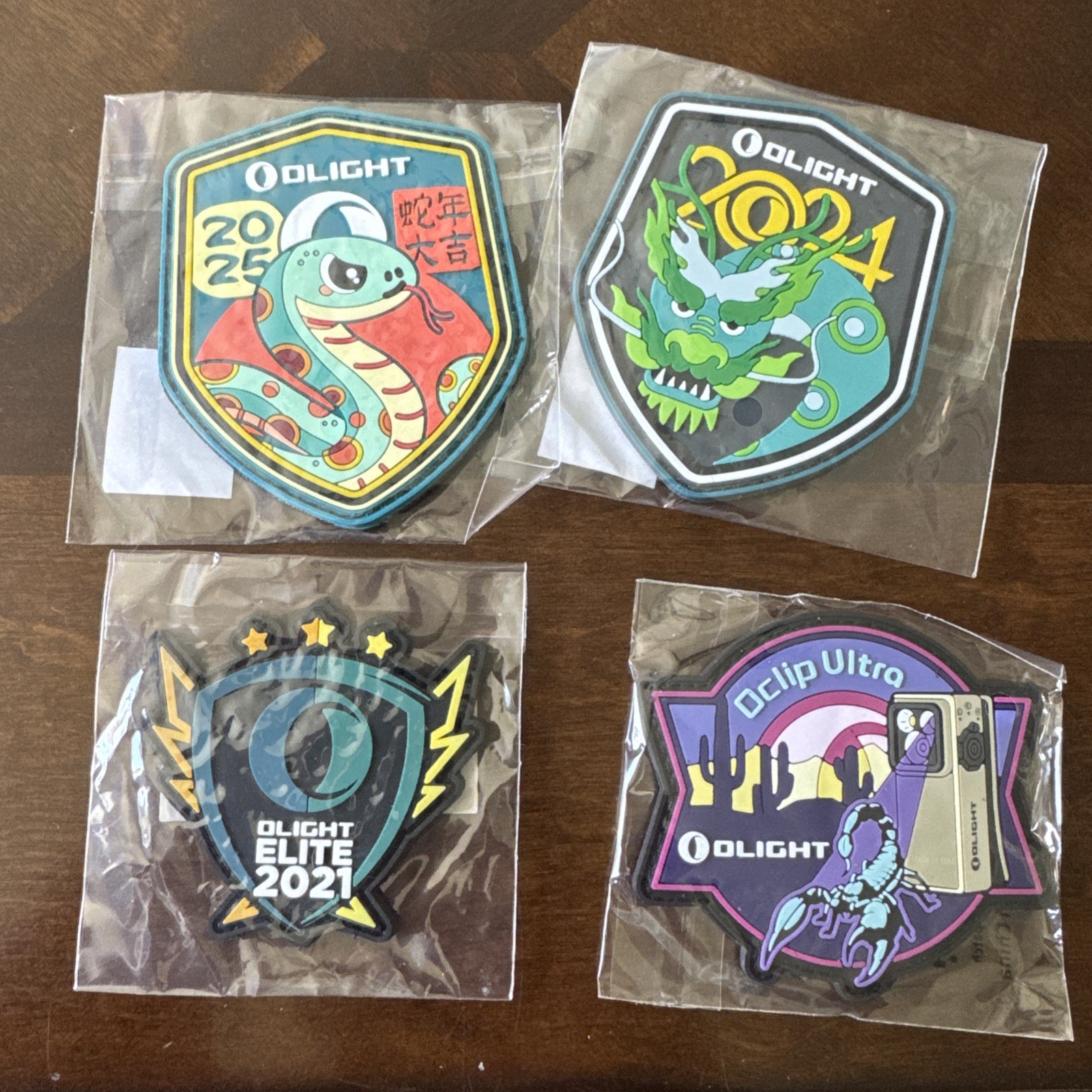 Olight Swag Patches. 2025 New Year, 2024 New Year, 2021 Elite, & Oclip Ultra.