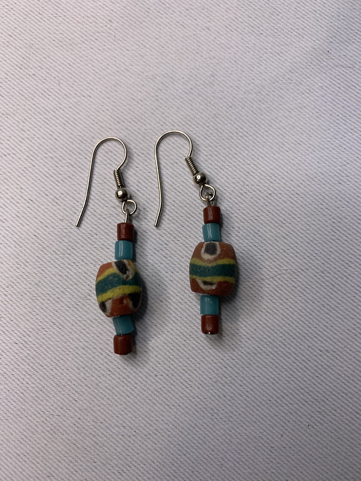 Silvertone and painted wood pierced earrings
