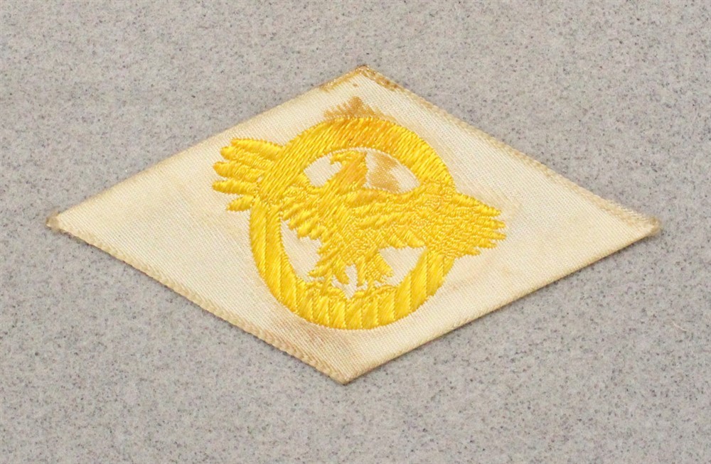 Cloth Military Badge 054: WWII Discharge Diamond, Ruptured Duck - woven on white
