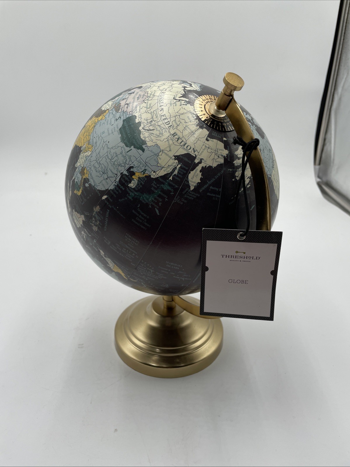 Threshold Arsha decorative world globe with a metallic gold stand and base
