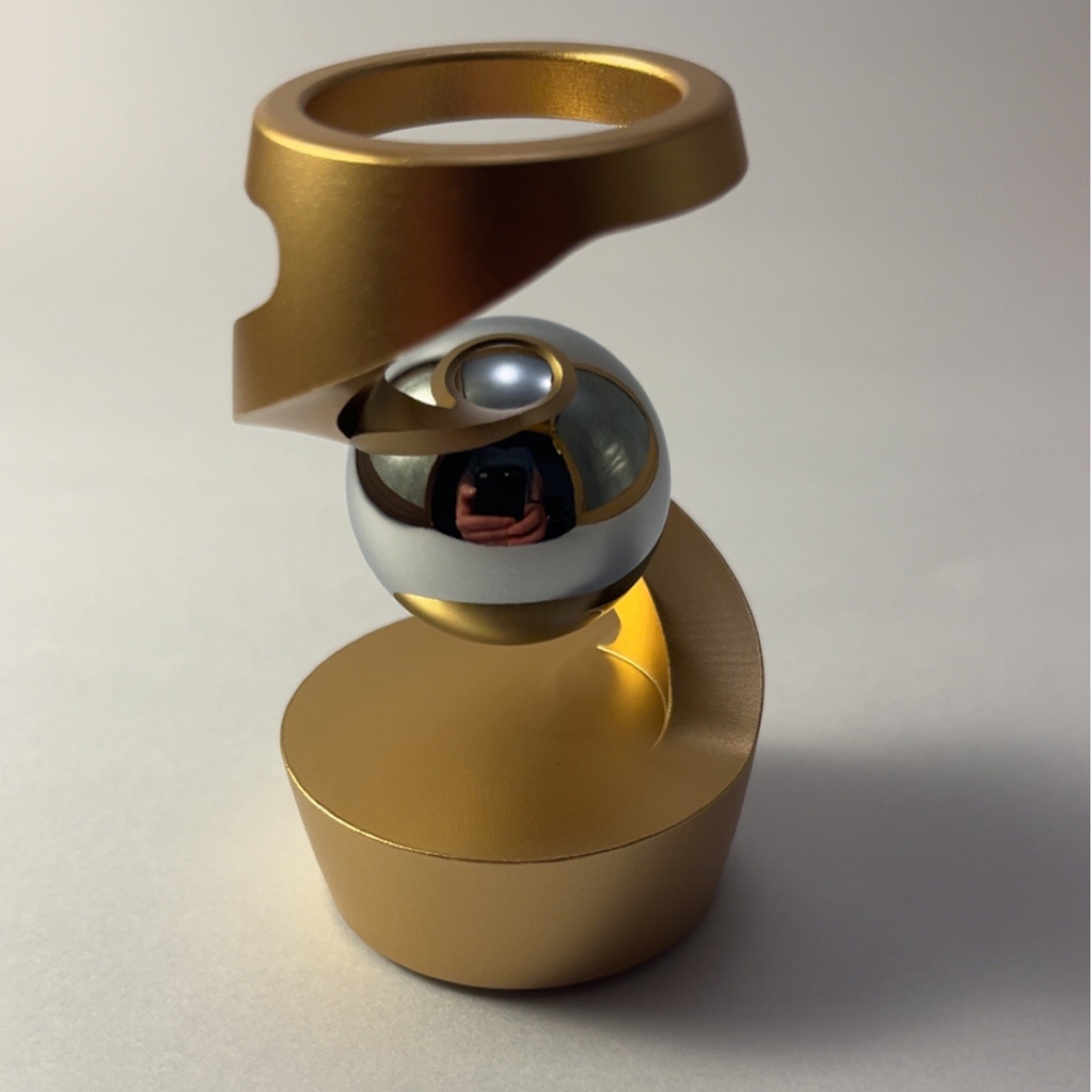 Kinetic Spinning Desk Toy with levitating steel ball illusion.