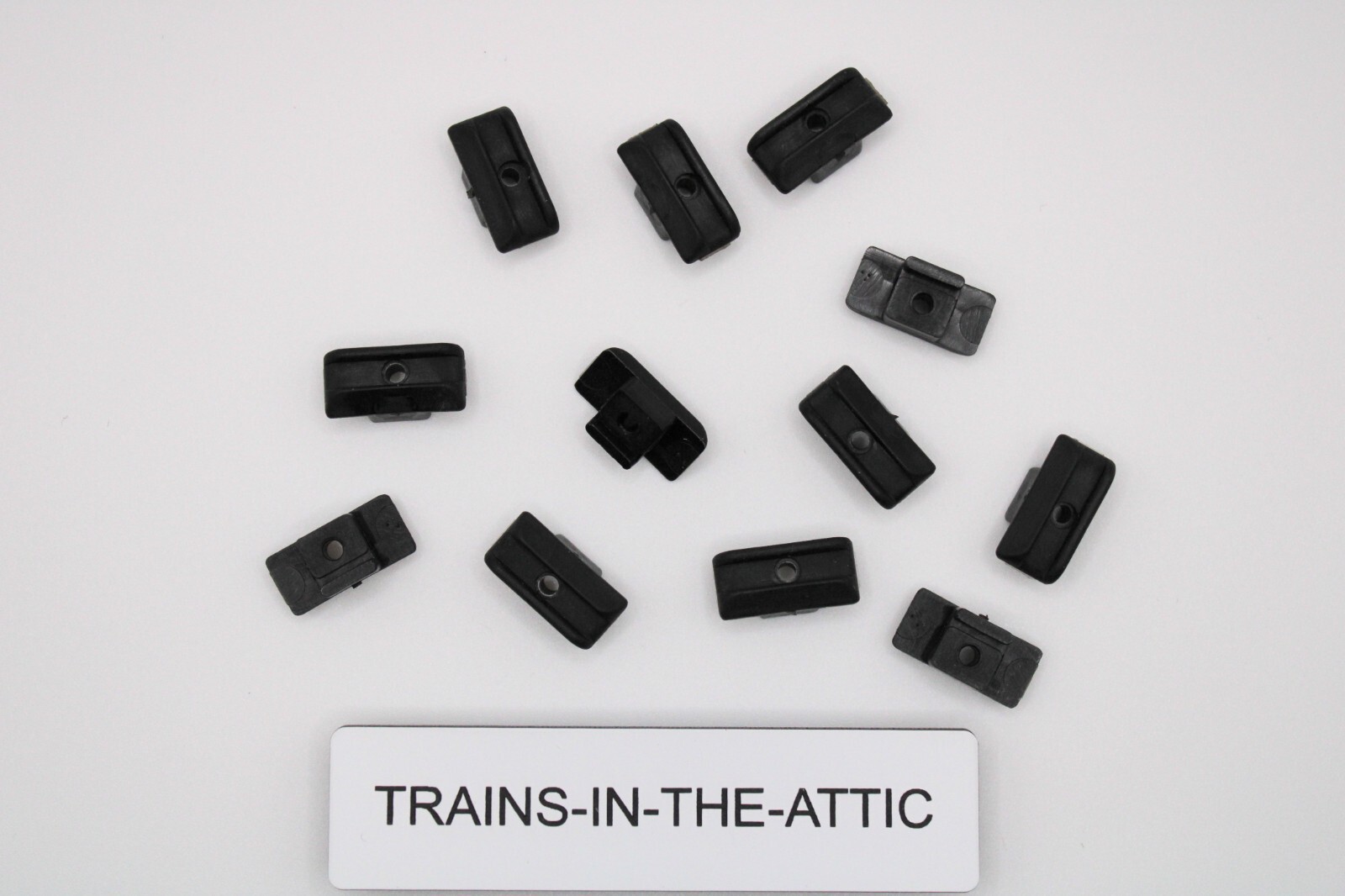 LIONEL POSTWAR BLACK PLASTIC COLLECTOR SLIDE SHOE. TT-208. NEW. P ACK OF (12)