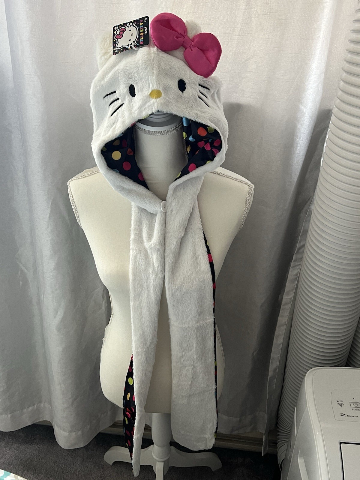 Hello Kitty Hat Hood in white with a pink bow and a polka dot lining.
